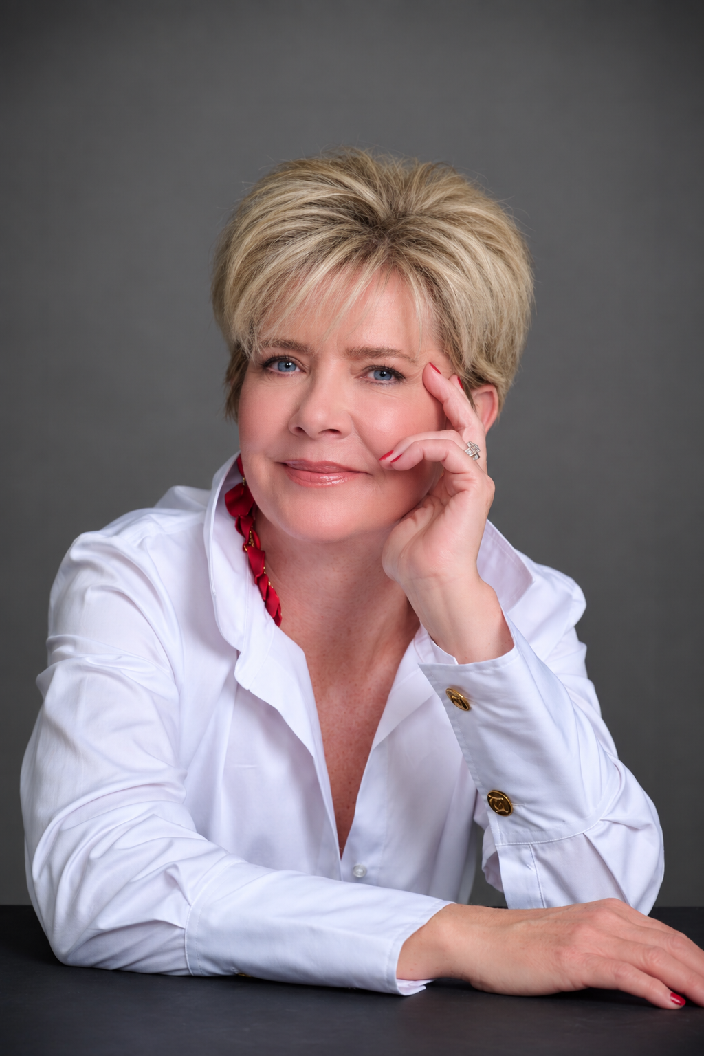Professional portrait of Allison Fisher MBE with soft bangs