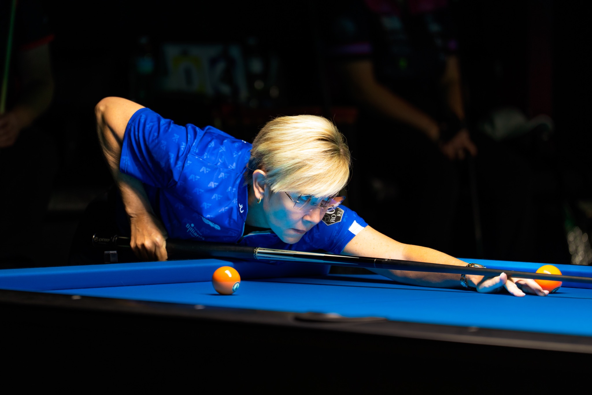 Allison Fisher stretching across the pool table during competition